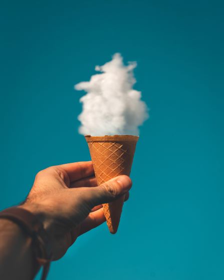man holding ice cream cone with a cloud 